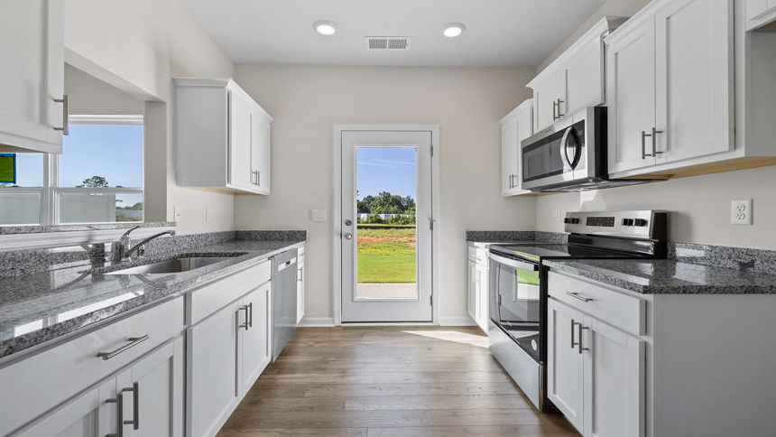 Kitchen with countertops and door to exterior.