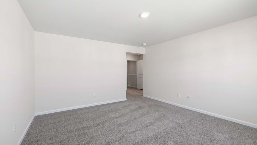 Bedroom with carpet and window.