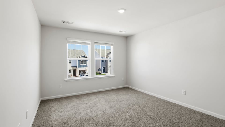 Bedroom with carpet and window.