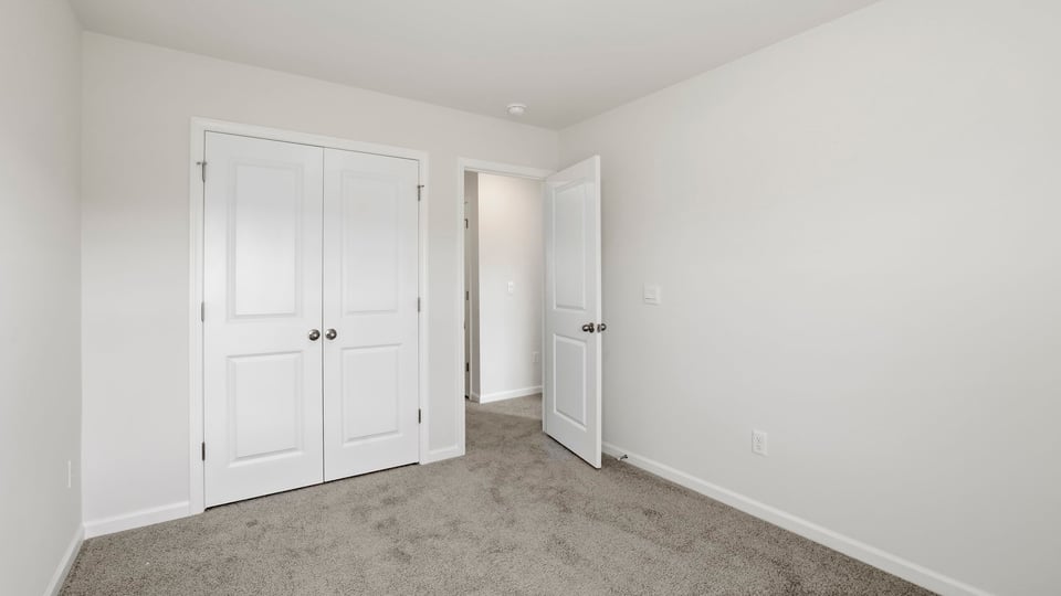Bedroom with carpet and window.