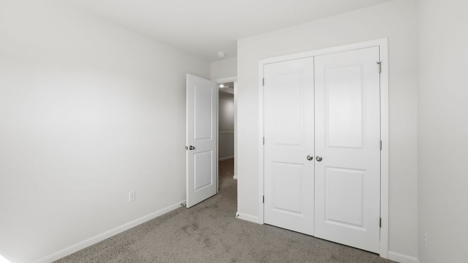 Bedroom with carpet and window.