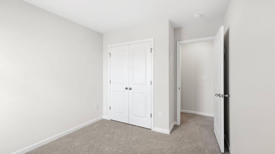 Bedroom with carpet and window.