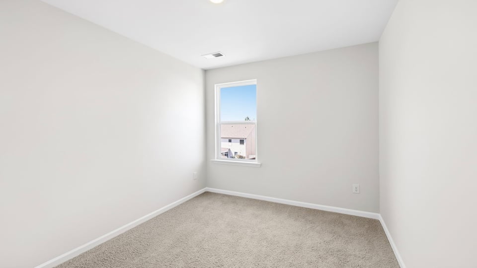 Bedroom with carpet and window.