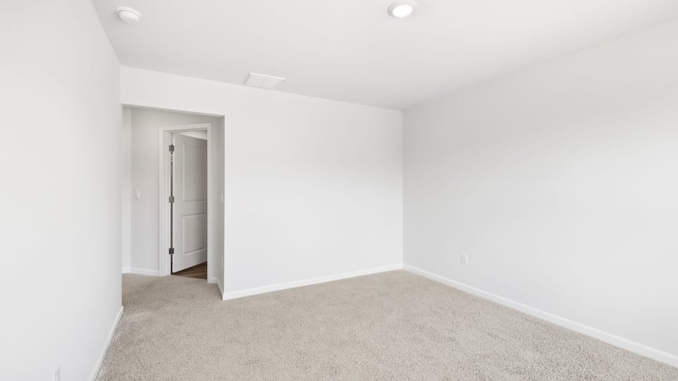 Bedroom with carpet and window.