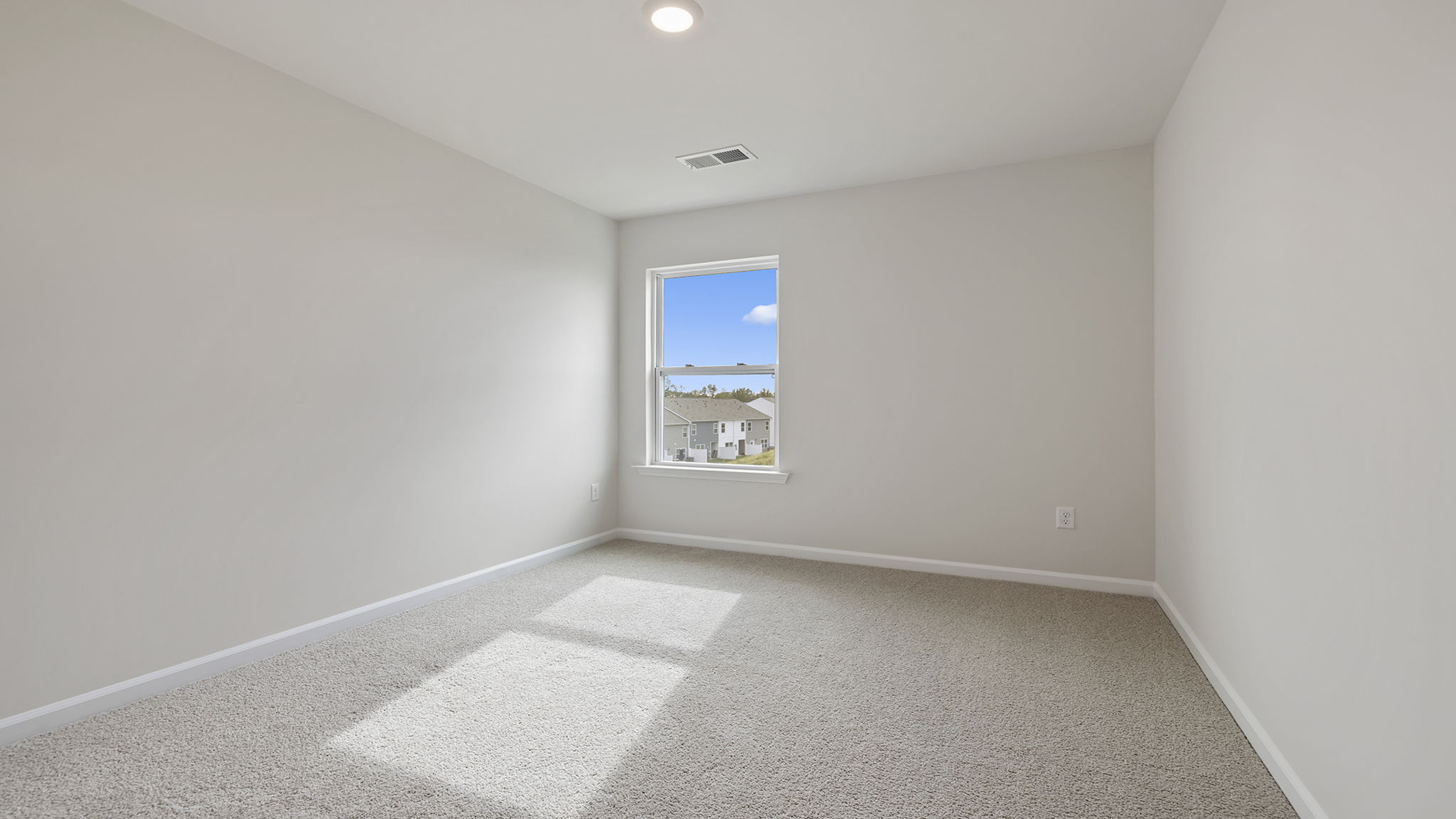 Bedroom with carpet and window.