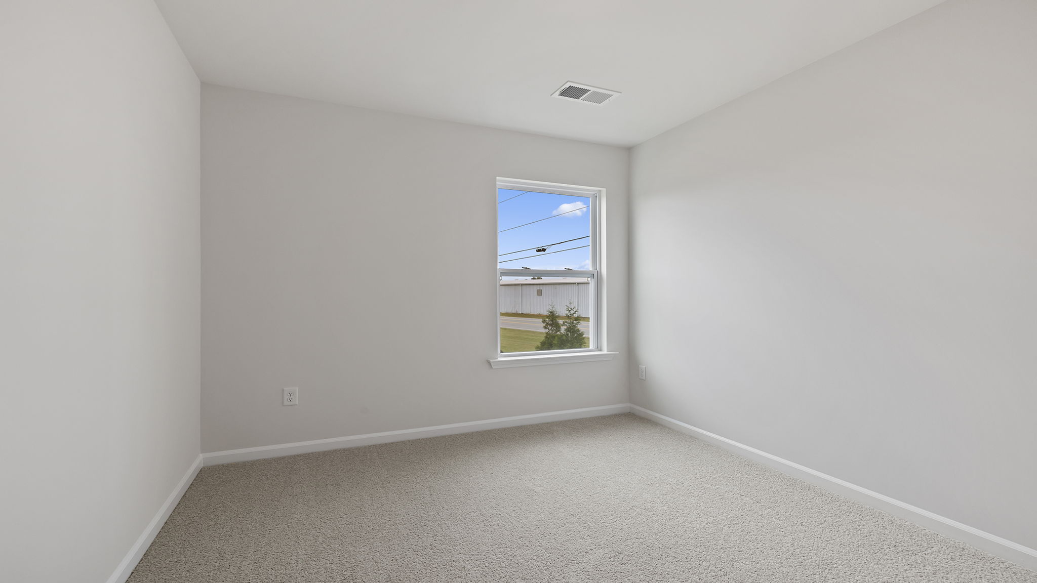 Bedroom with carpet and window.