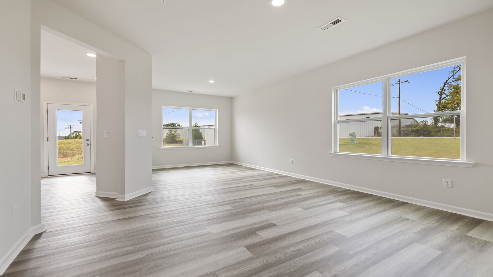 Livingroom with windows and kitchen.