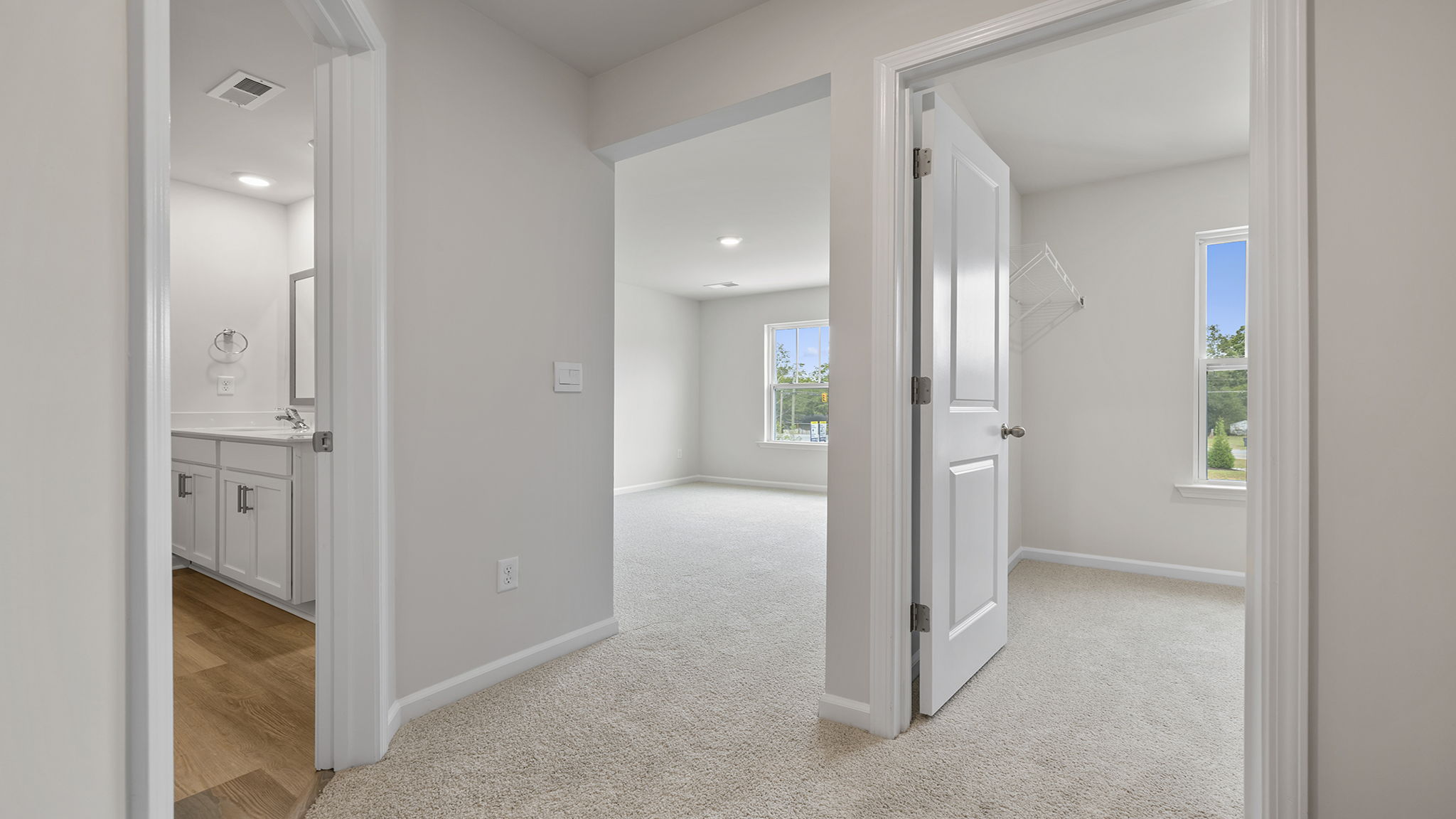 Bedroom with carpet and windows.