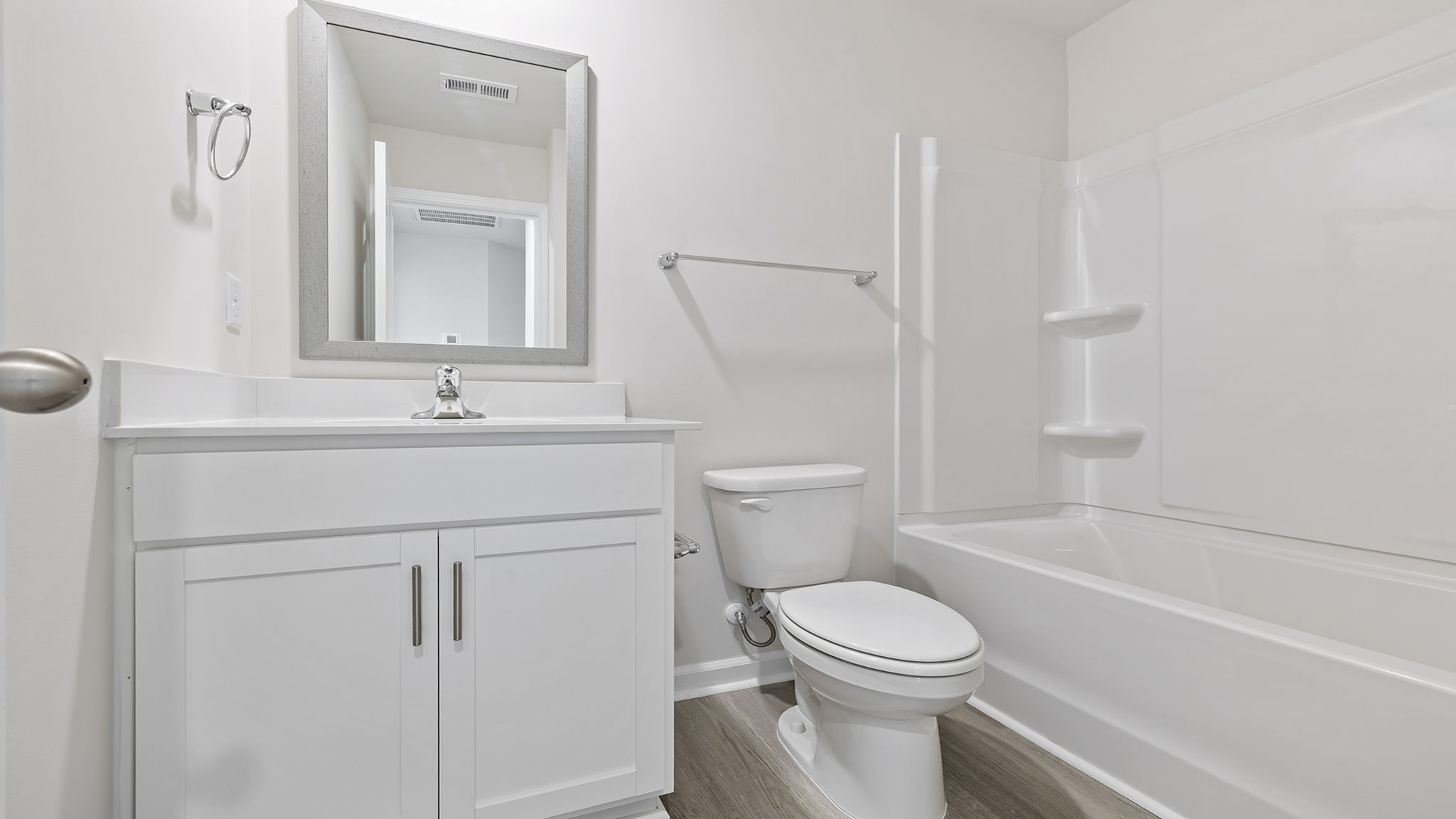 Bathroom with vanity and walk in shower.