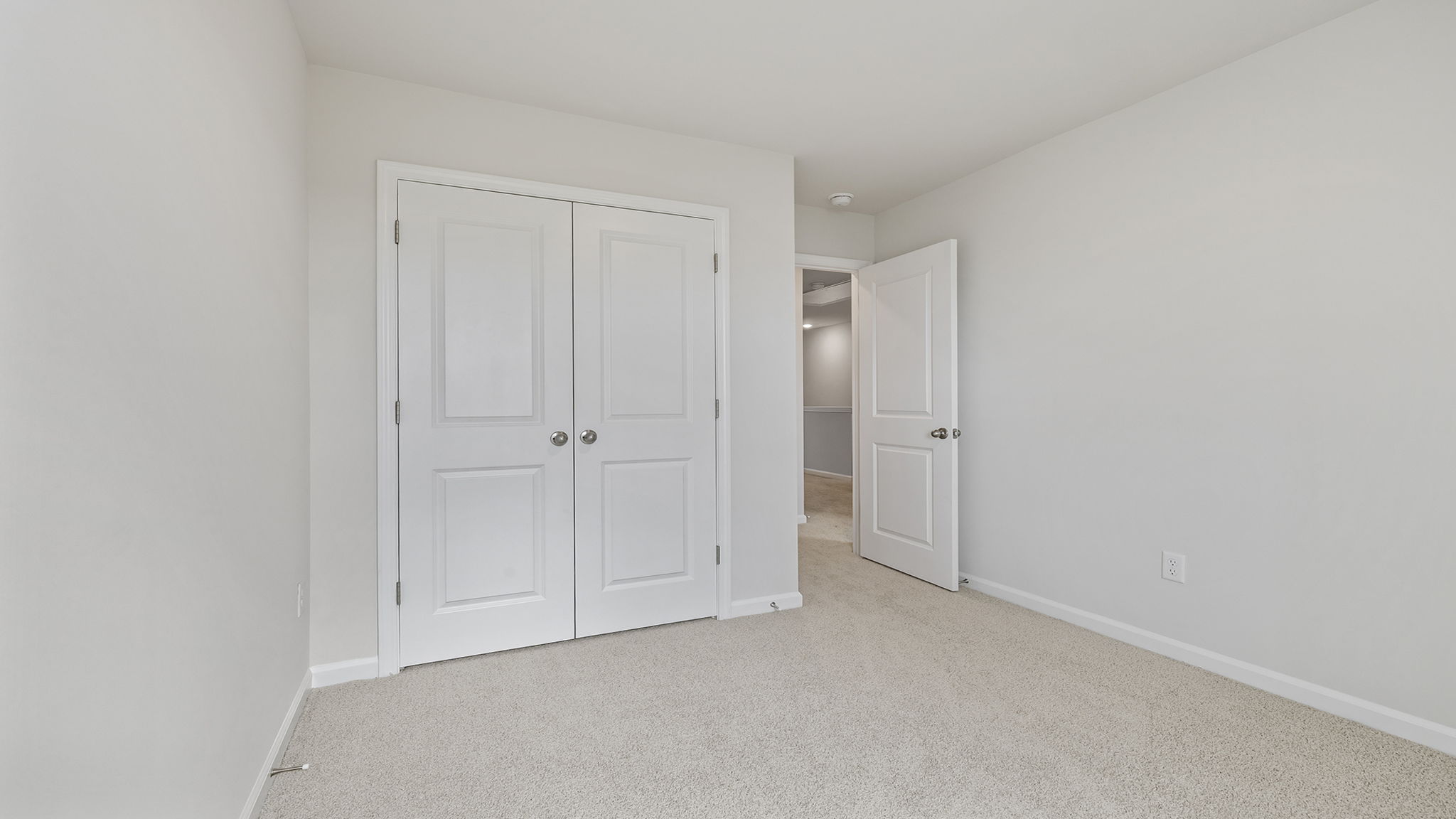 Bedroom with carpet and window.