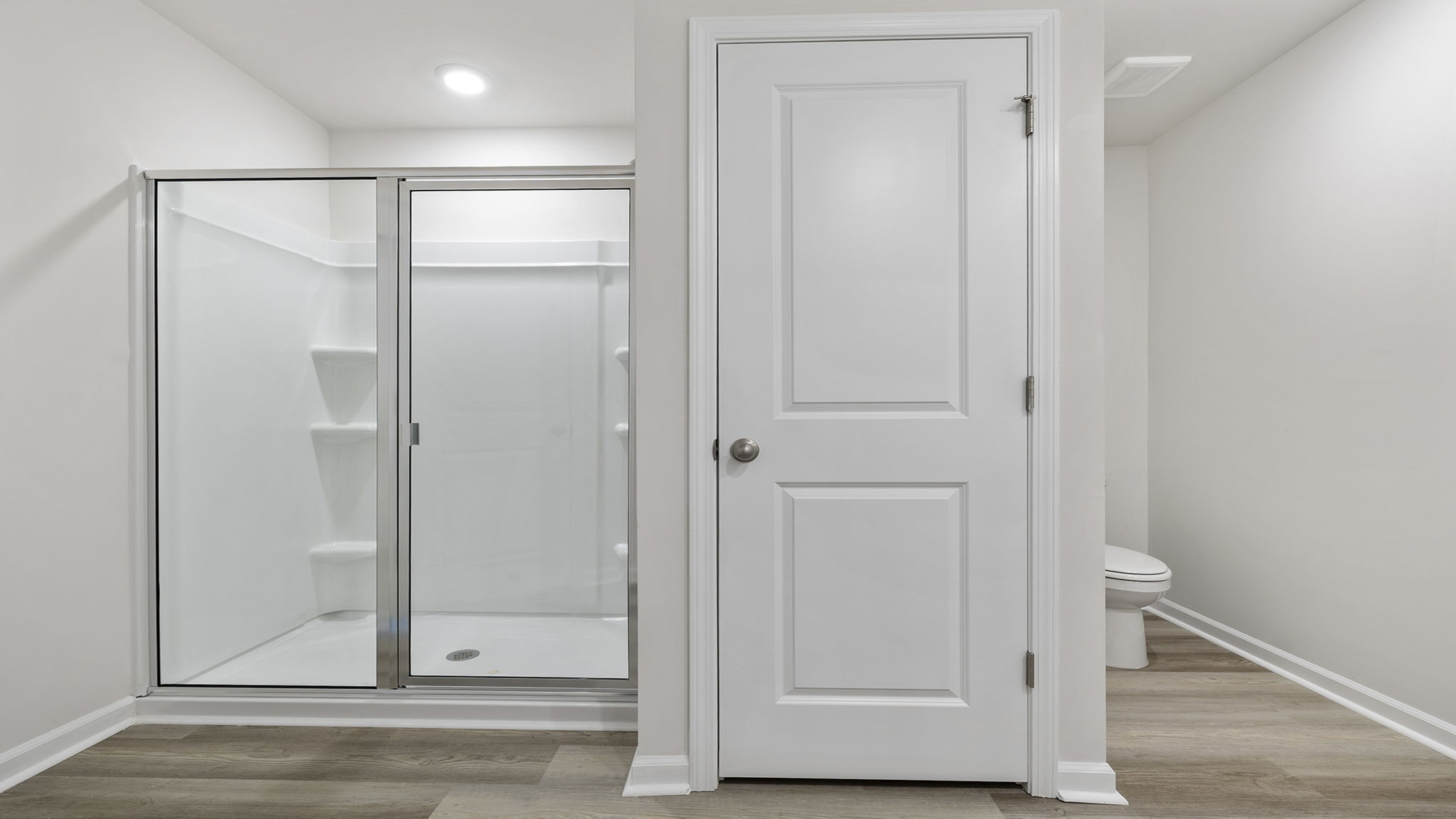 Bathroom with vanity and walk in closet.