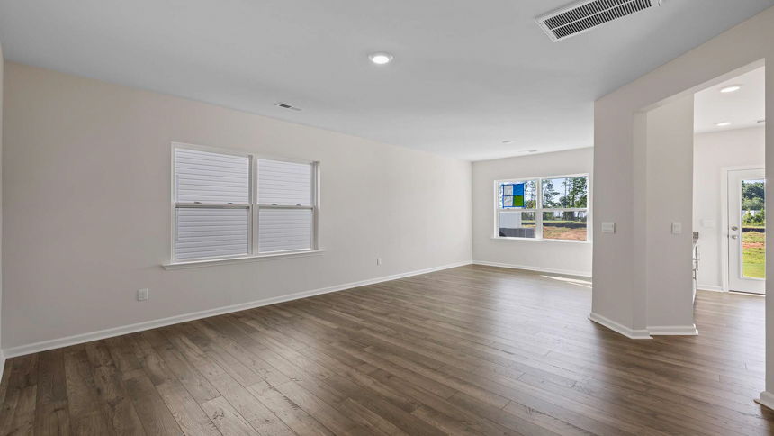 Living room and dining room with windows.