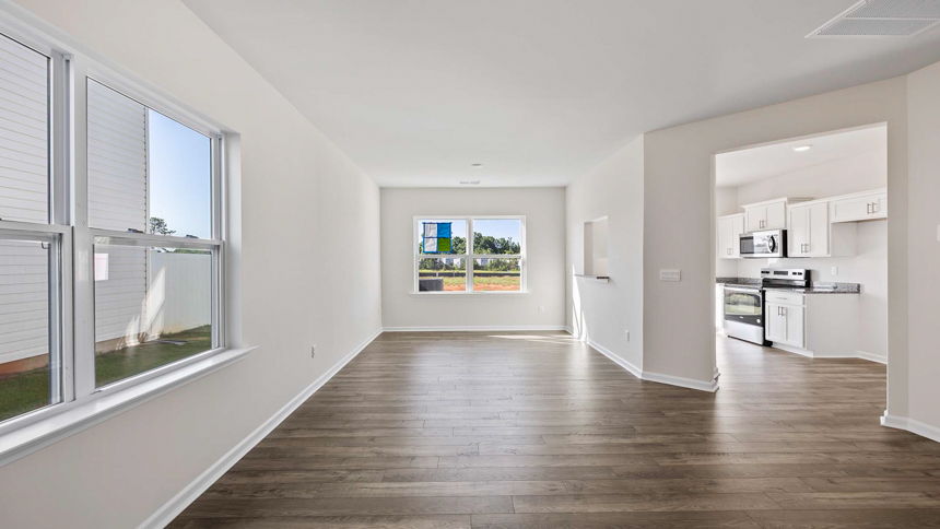 Living room and dining room with windows.