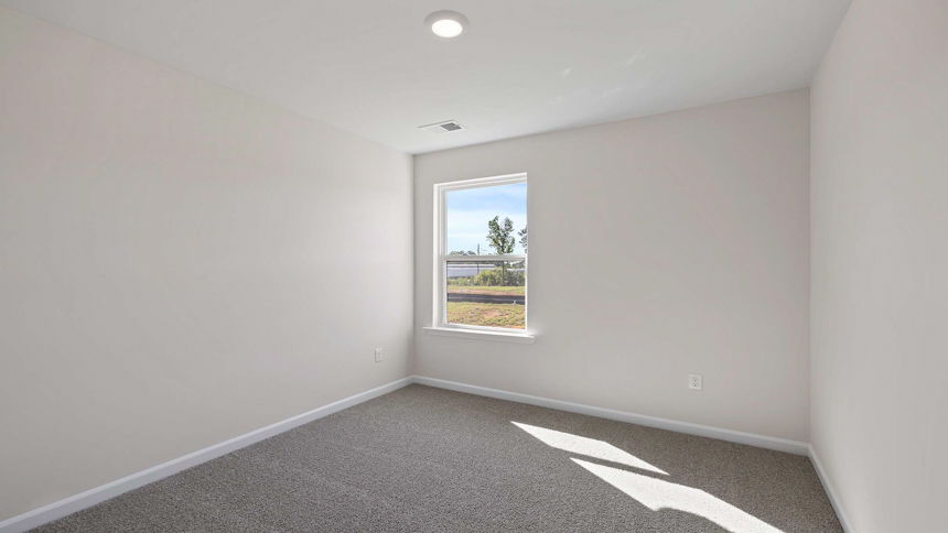 Bedroom with carpet and window.