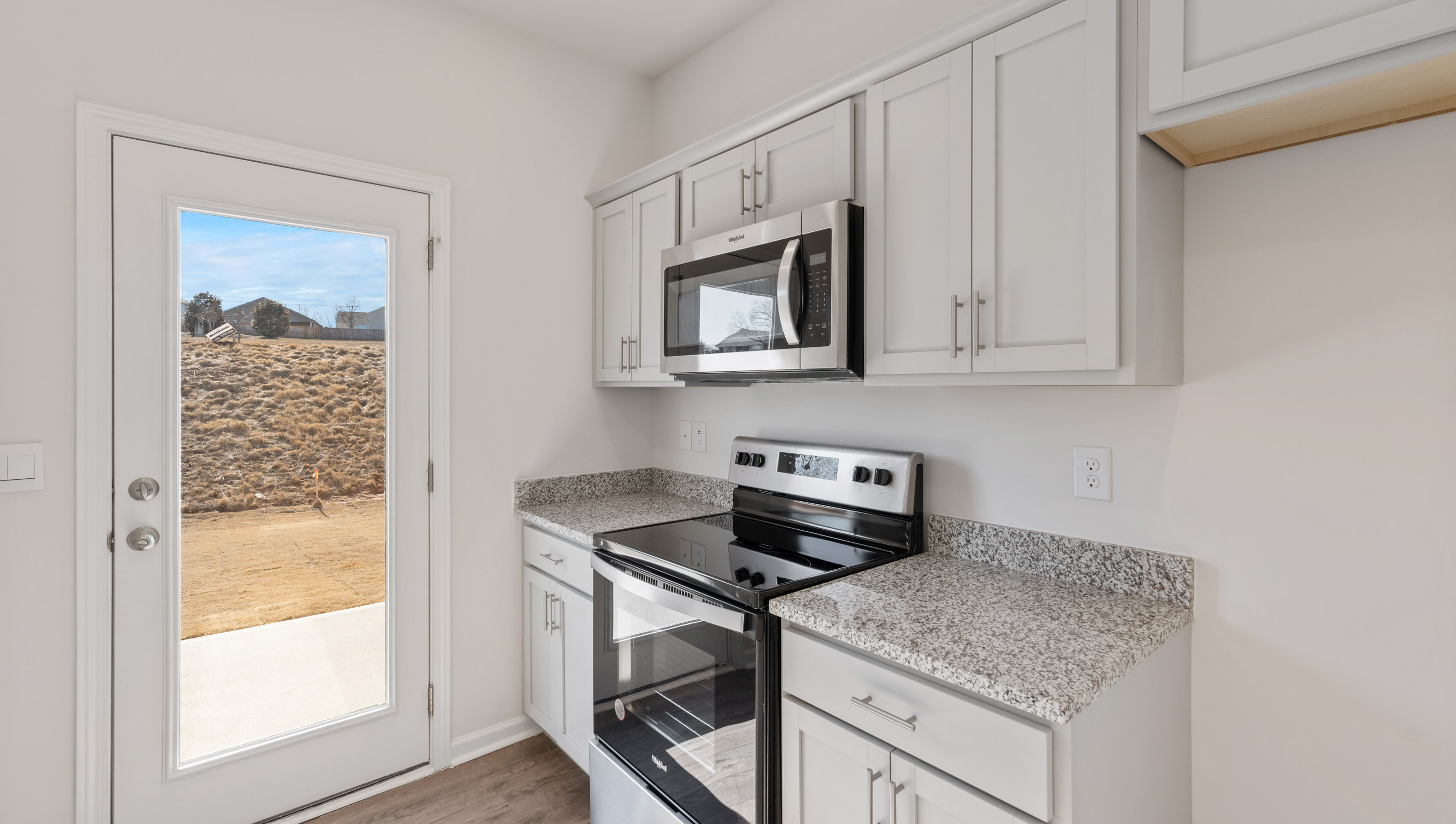 Kitchen with granite countertops and stainless steel appliances.