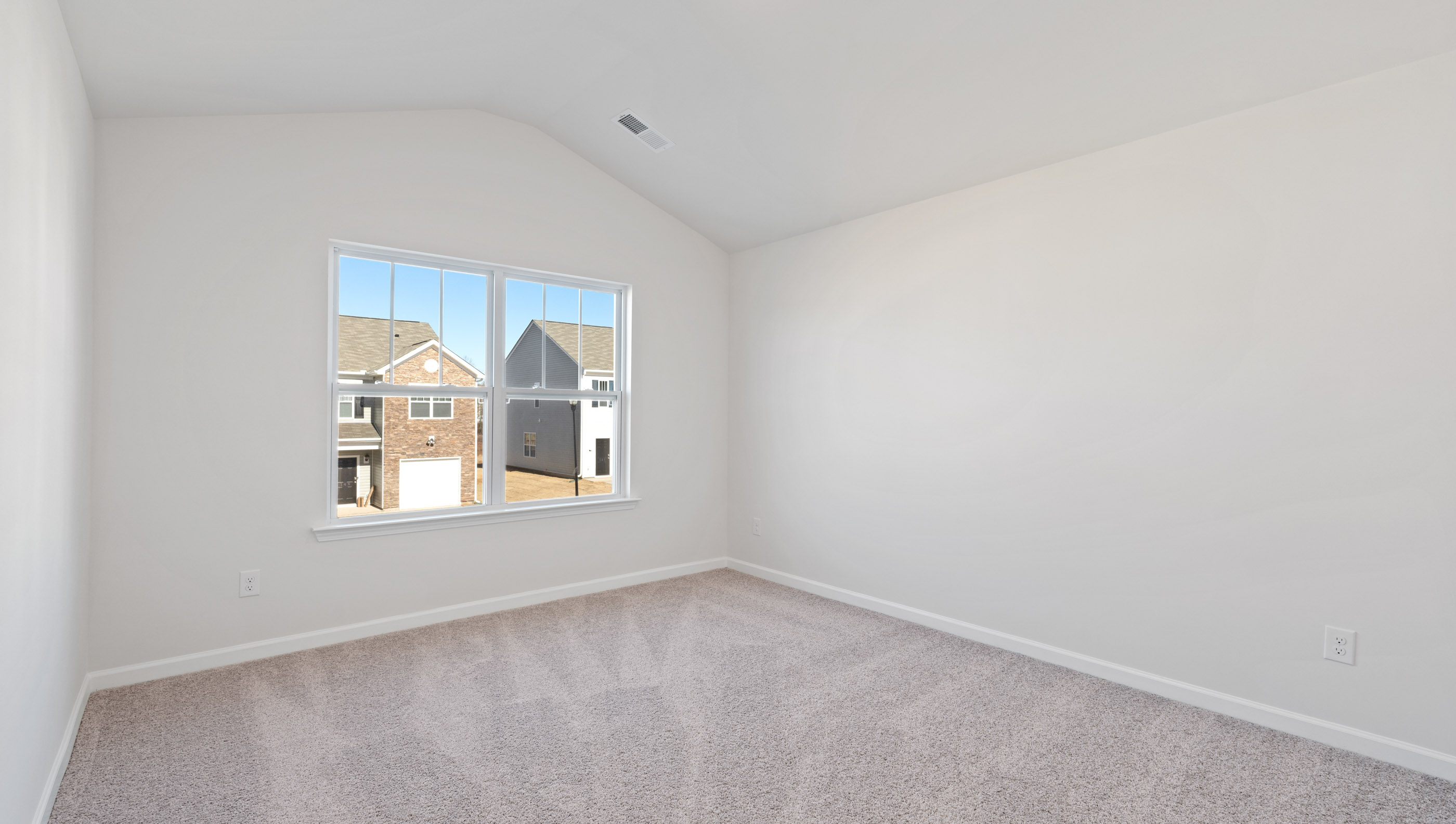 Bedroom with carpet and window.