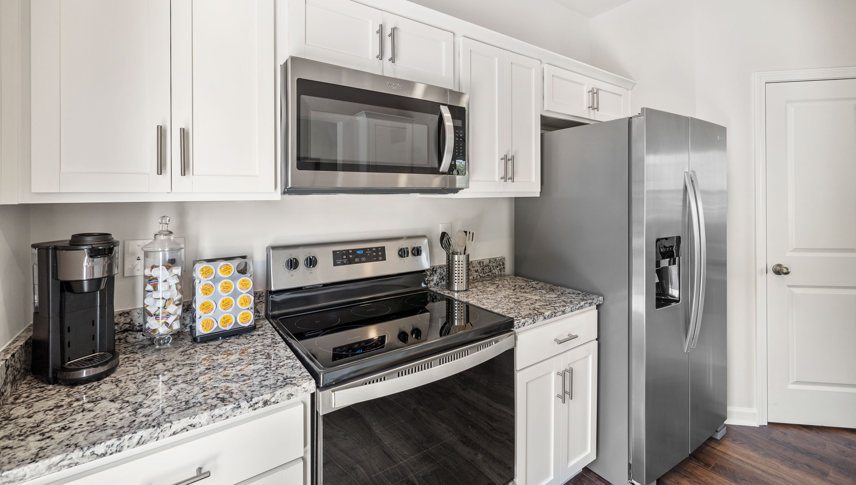 Kitchen and island with granite counter tops.