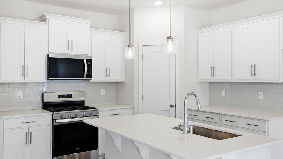 Kitchen with island and cabinets.