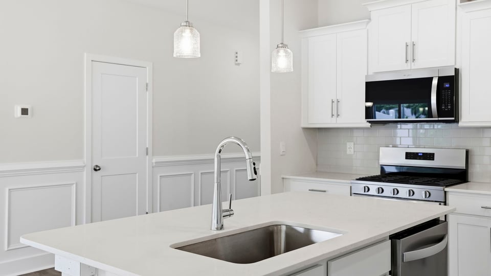 Kitchen with island and cabinets.
