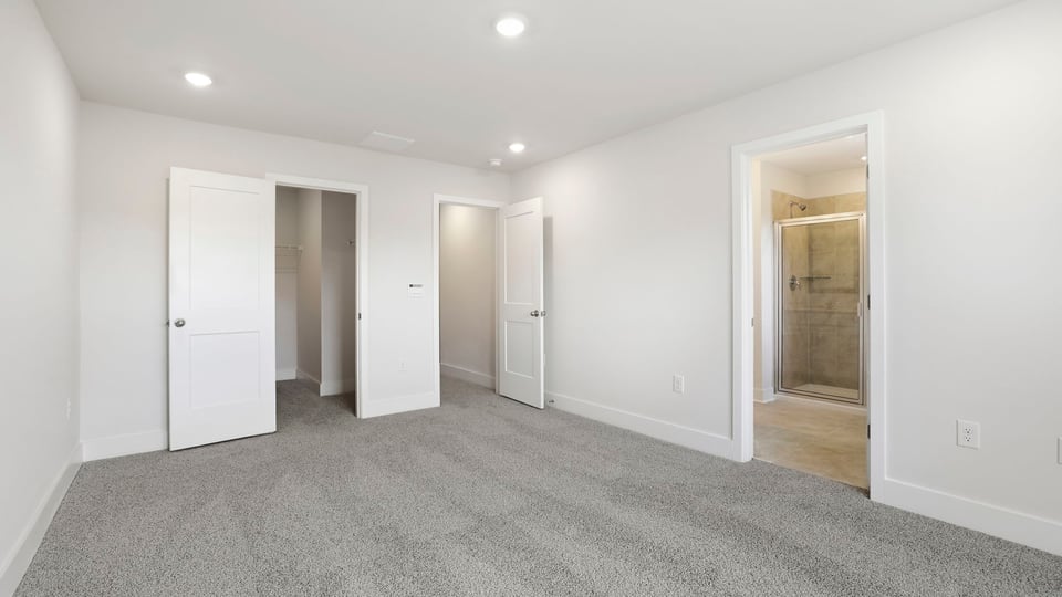 Bedroom with carpet and windows.