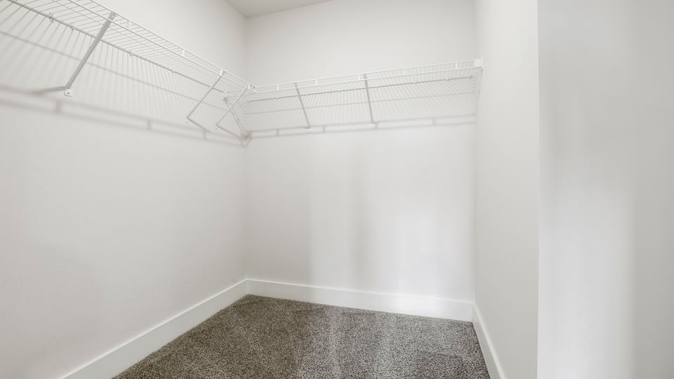 Primary closet with shelf.