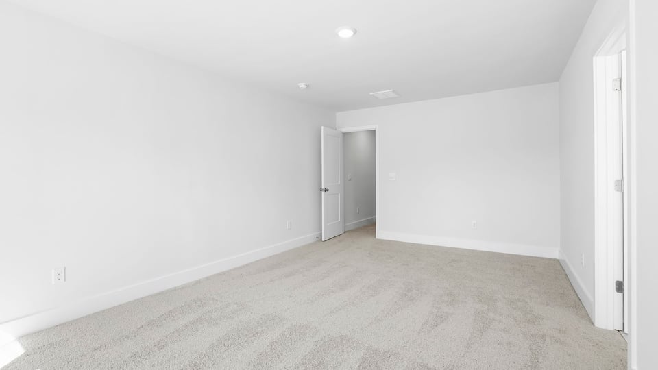 Bedroom with carpet and windows.
