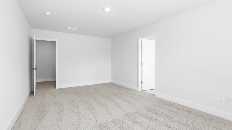 Bedroom with carpet and windows.