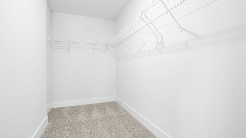 Primary closet with shelf.
