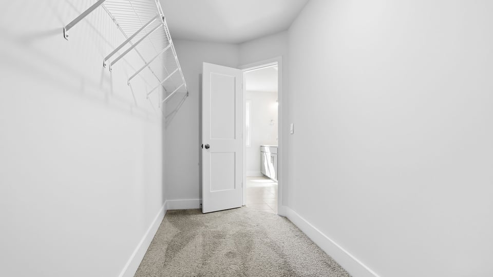 Primary closet with shelf.