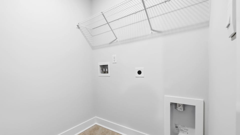 Laundry room with shelf.