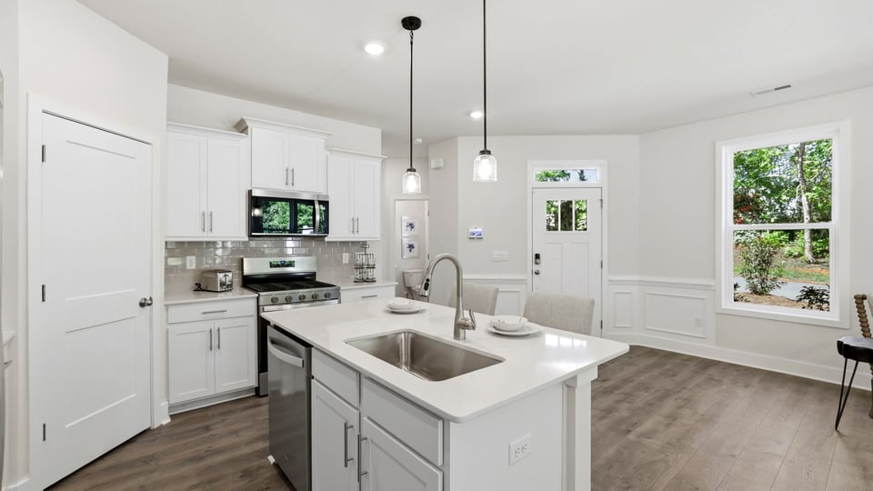 Kitchen with island and cabinets.
