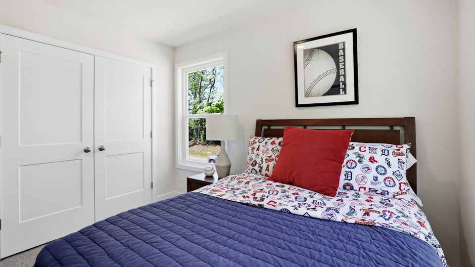 Bedroom with carpet and windows.