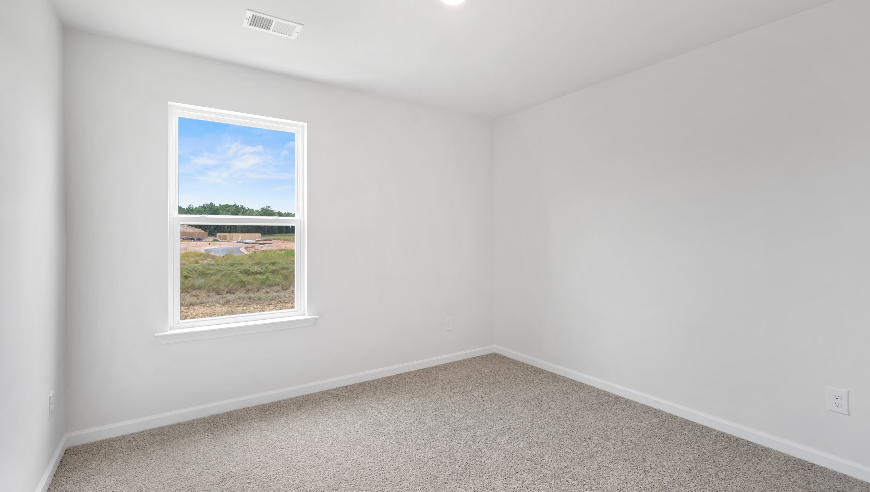 Bedroom with carpet and window.