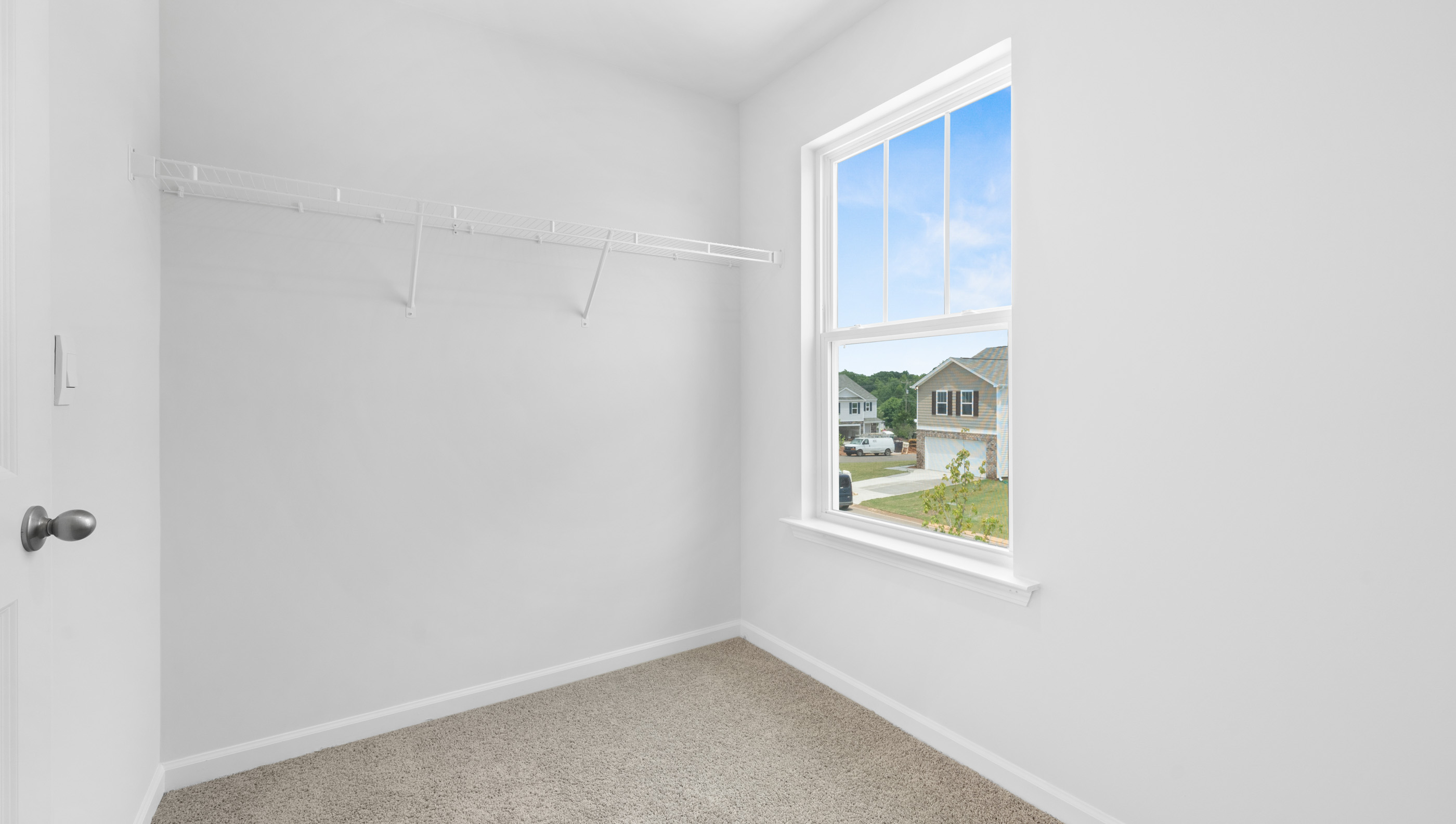 Bedroom with carpet and window.