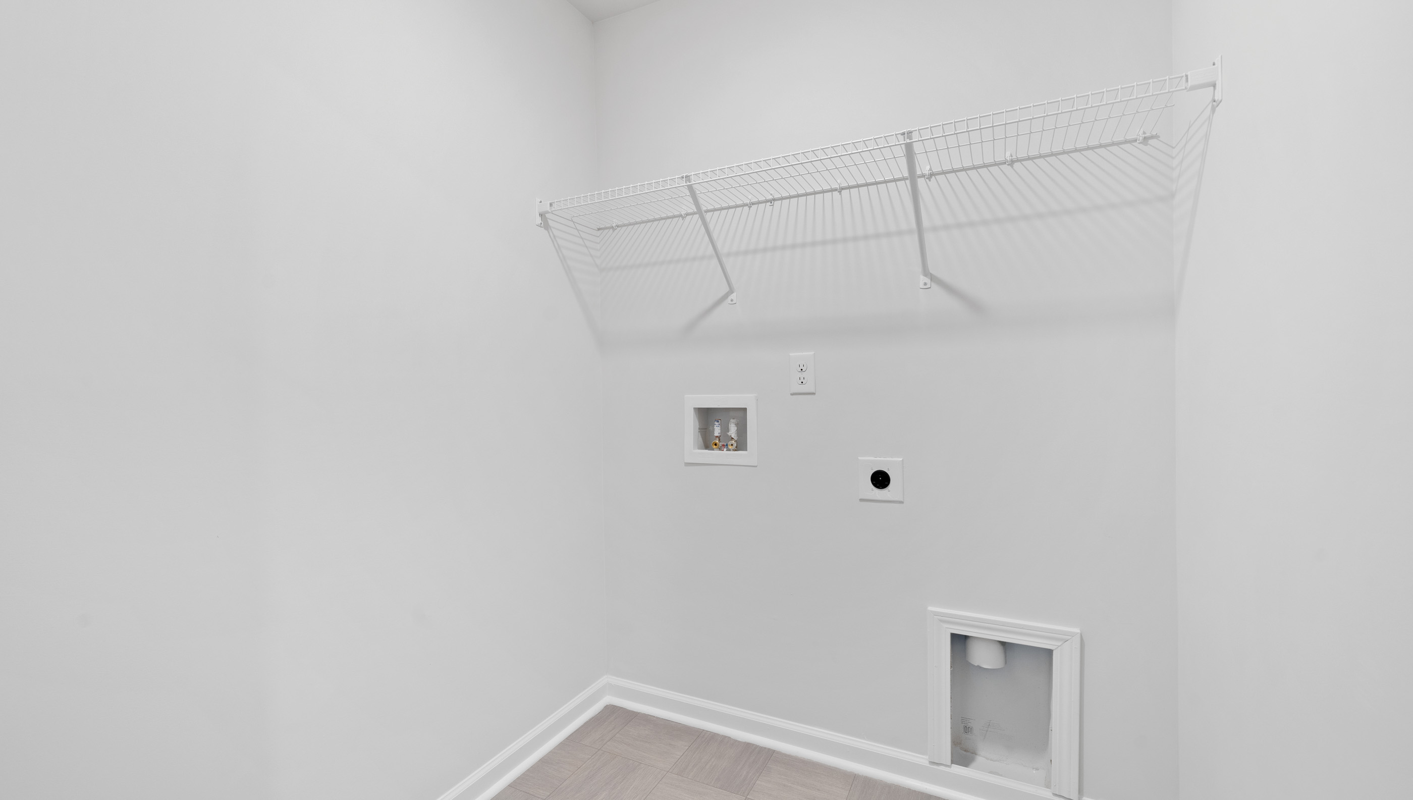 Laundry room with carpet.