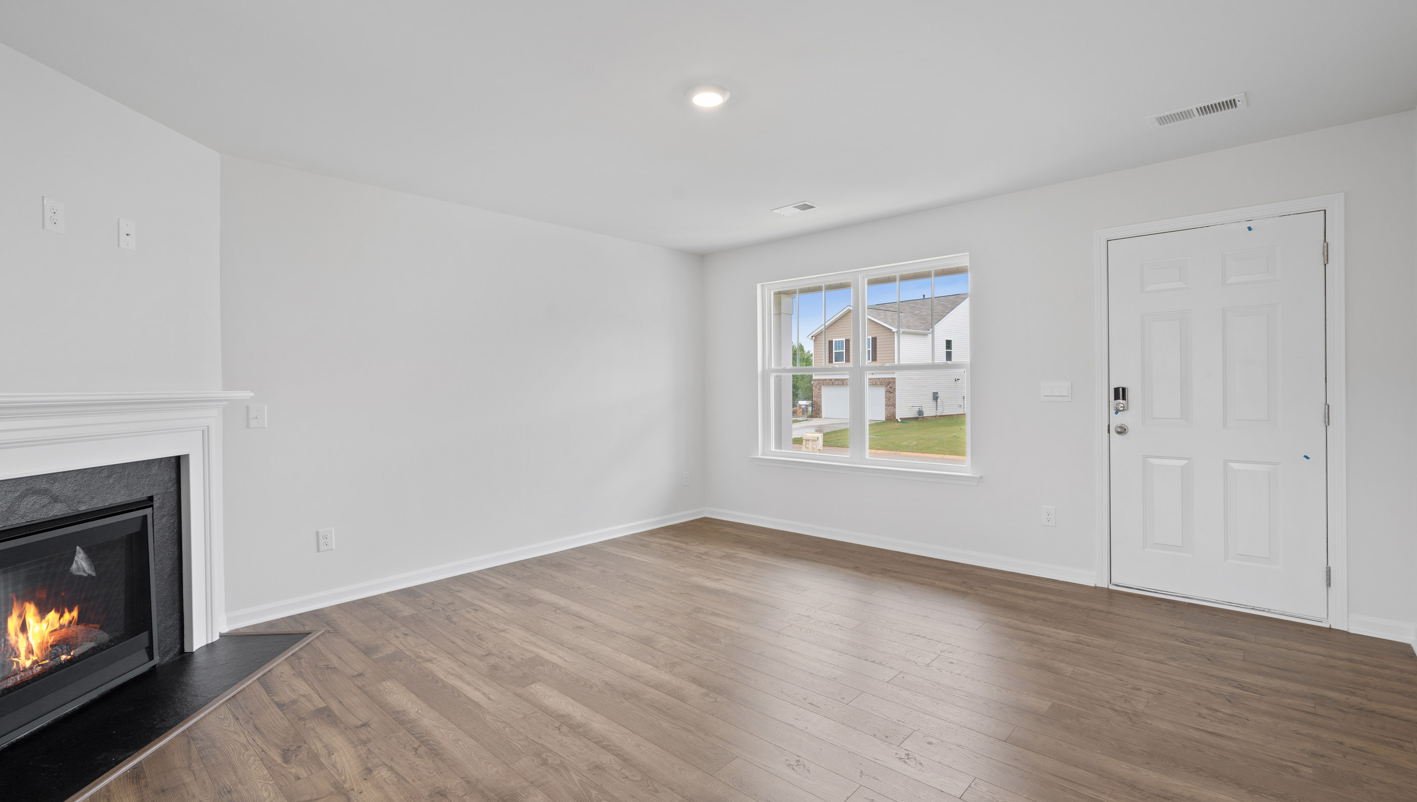 Family room with fireplace and windows.