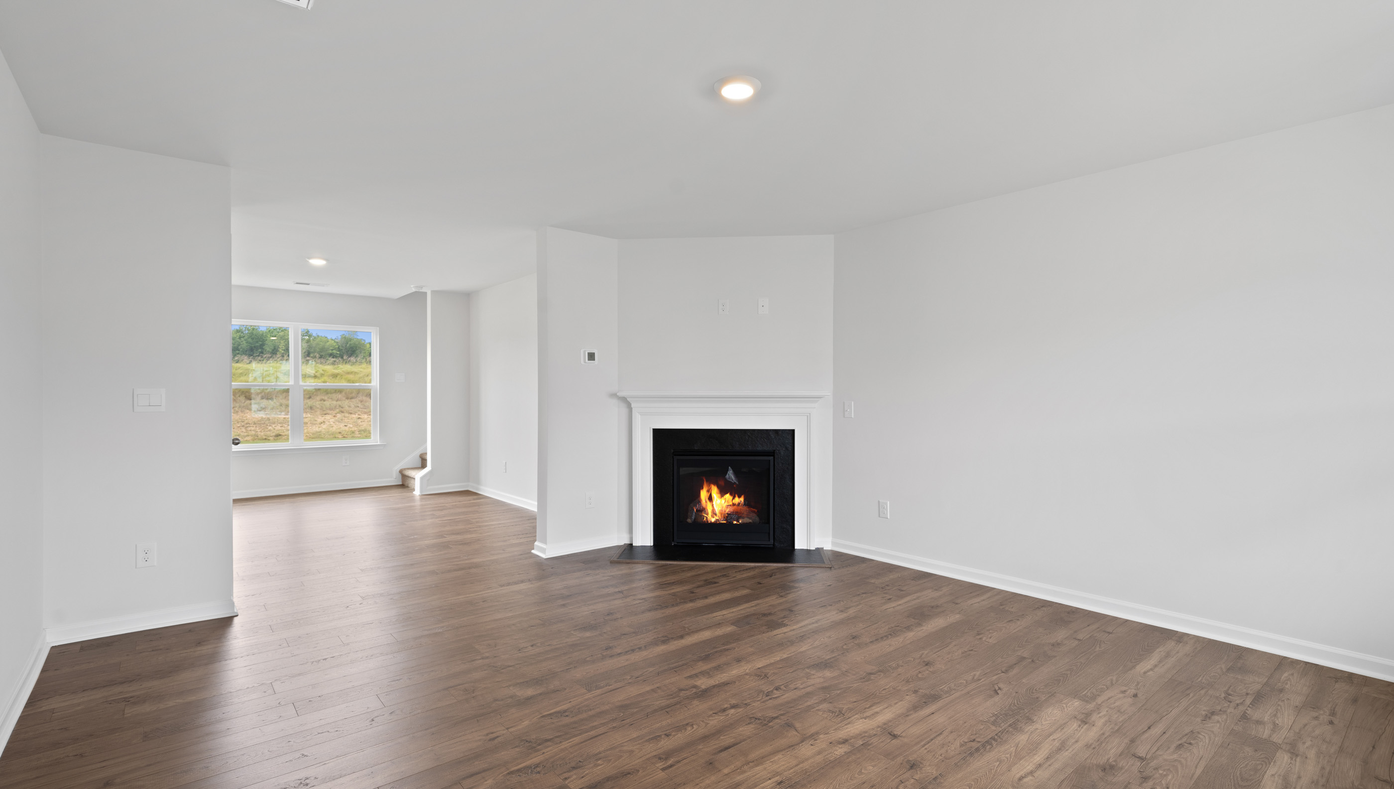 Family room with fireplace and windows.