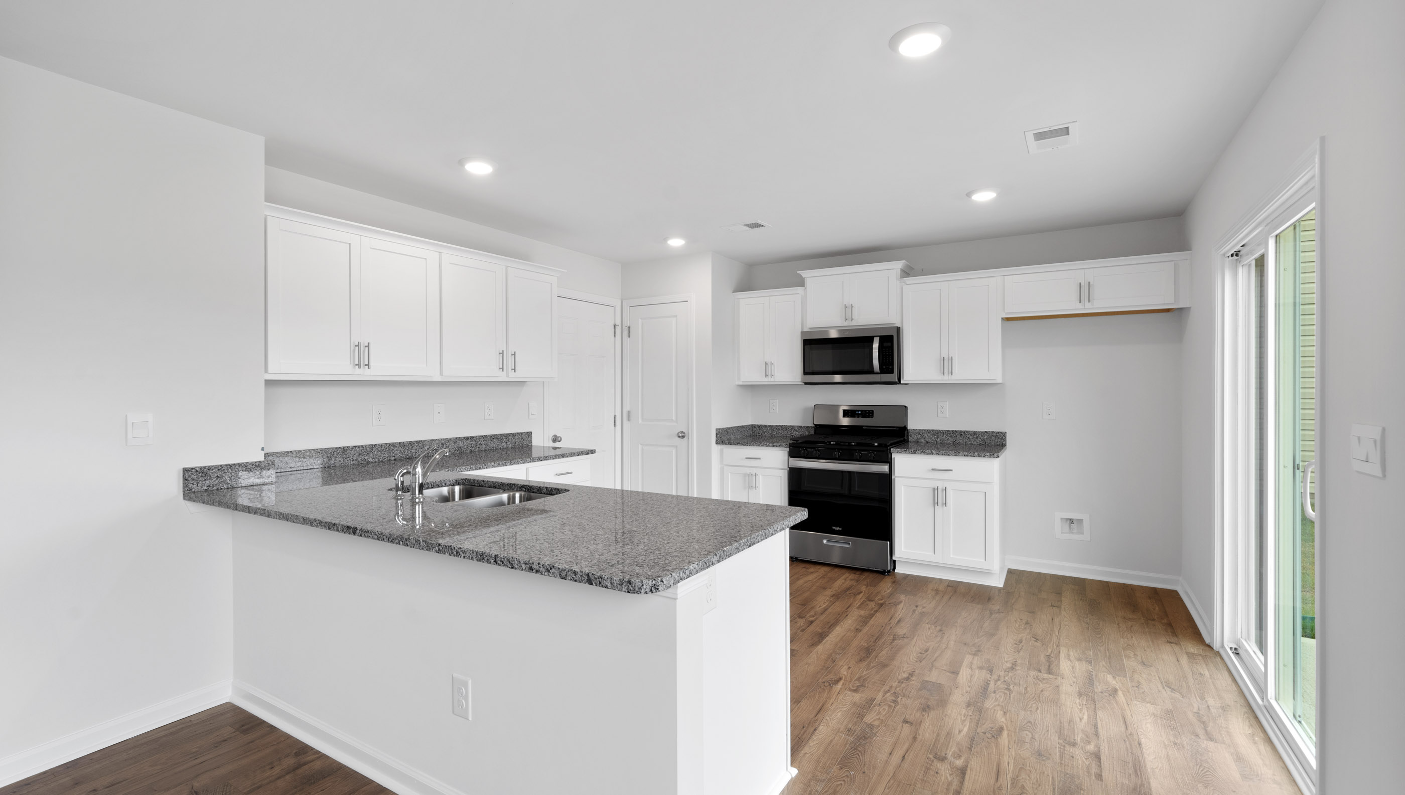 View of kitchen with granite counter tops.