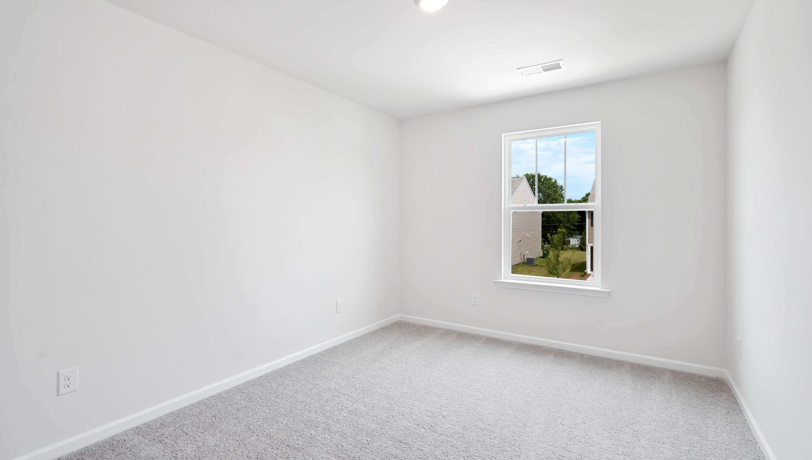 Bedroom with carpet and window.