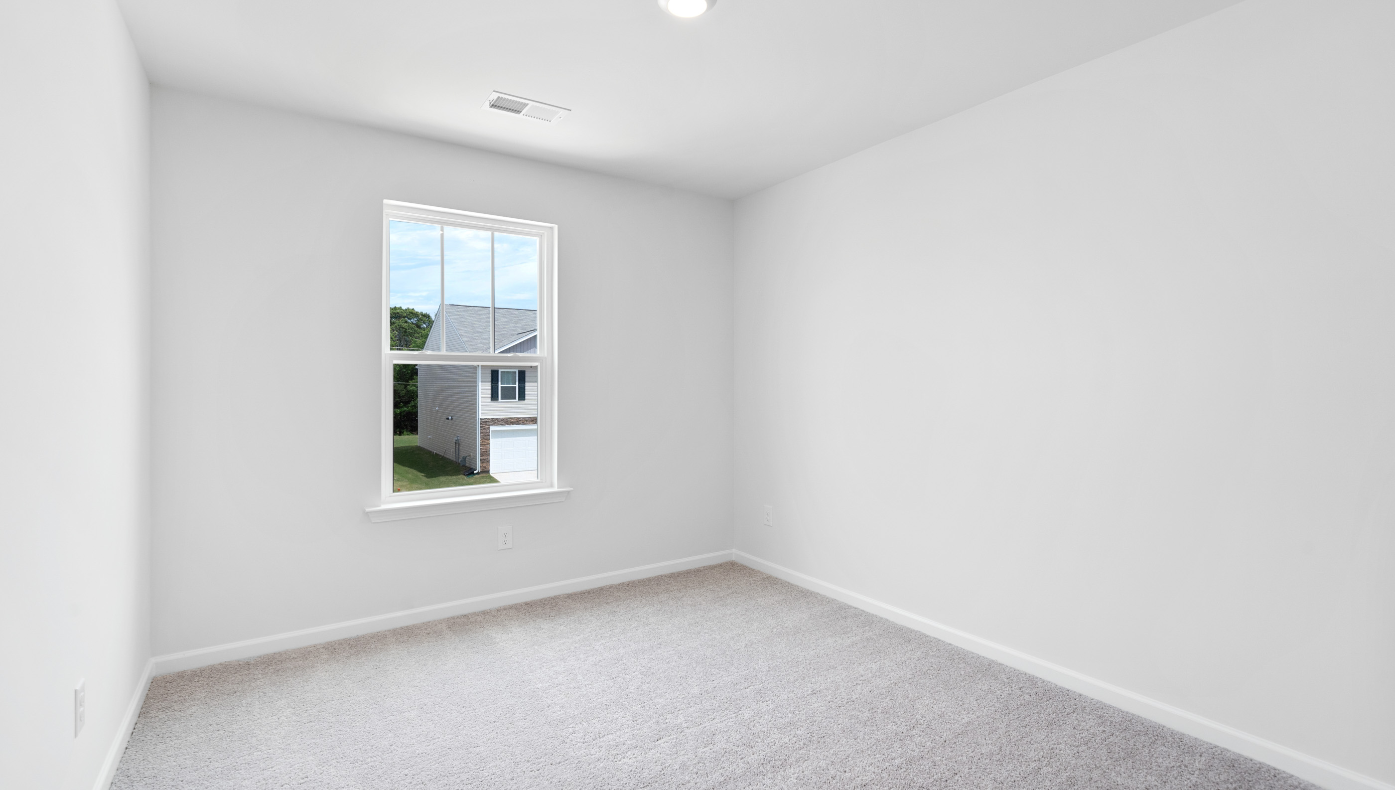 Bedroom with carpet and window.