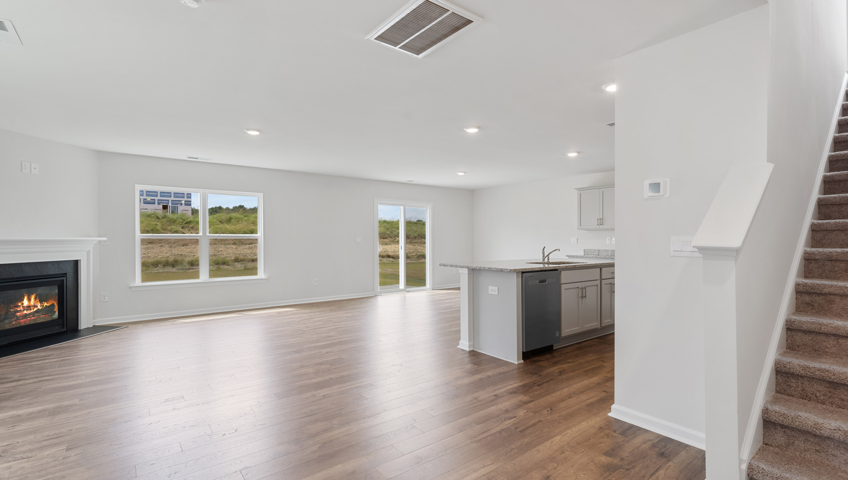 Family room with fireplace and view of stairs.