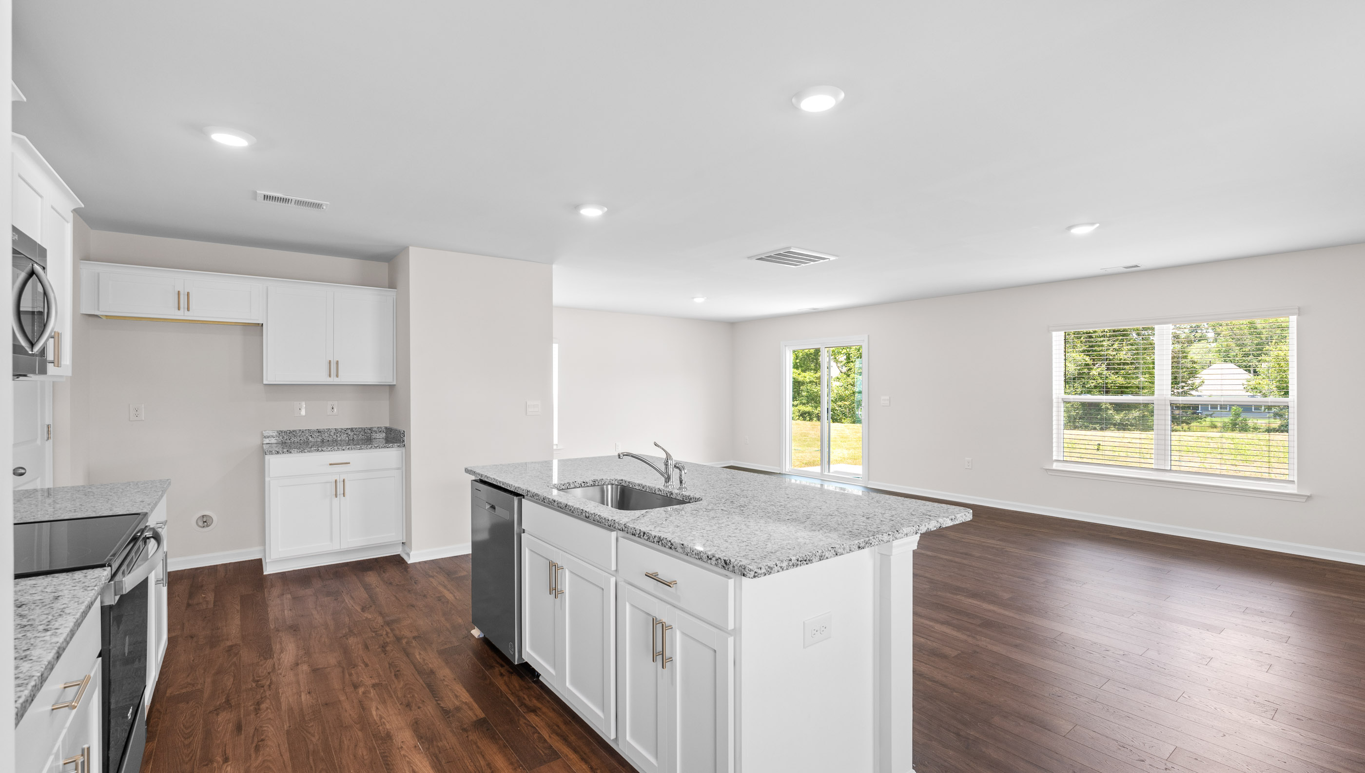 Kitchen and island with view of family room.