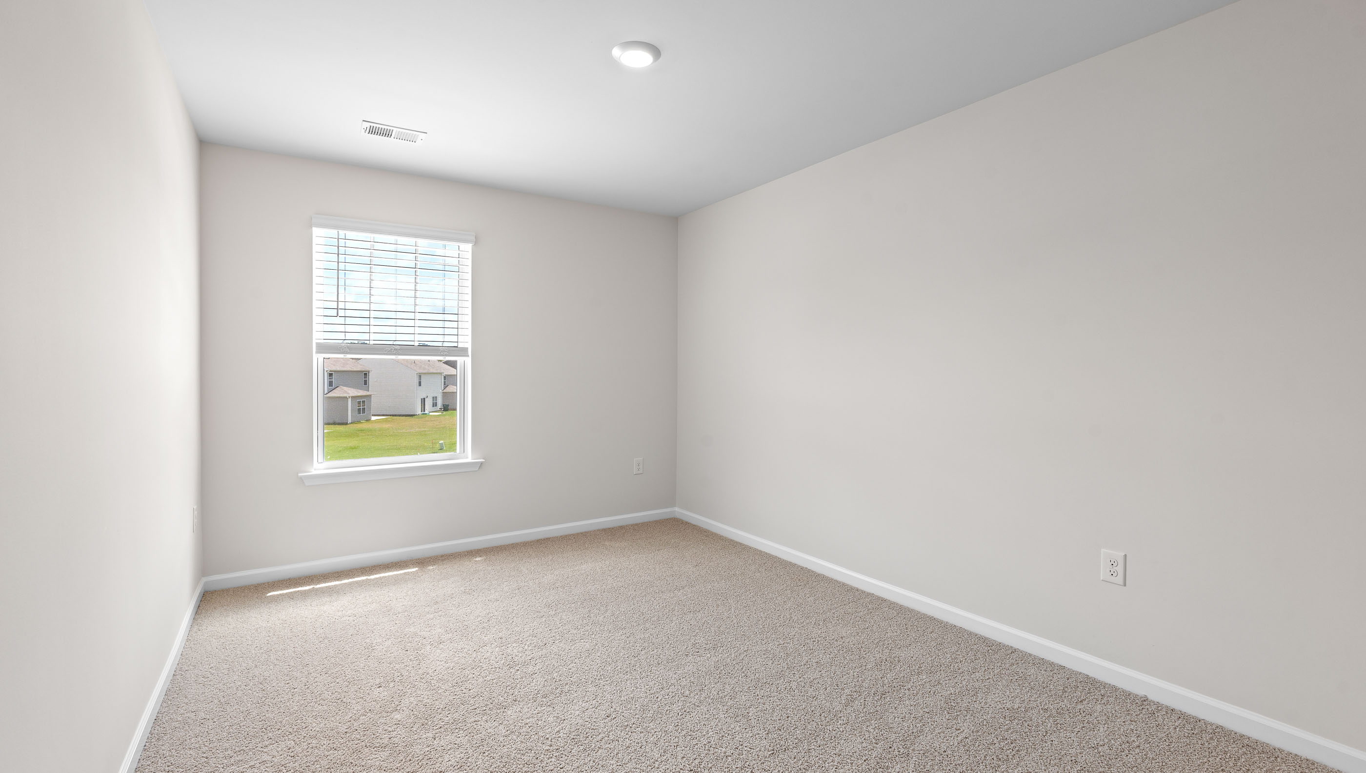 Bedroom with carpet and window.