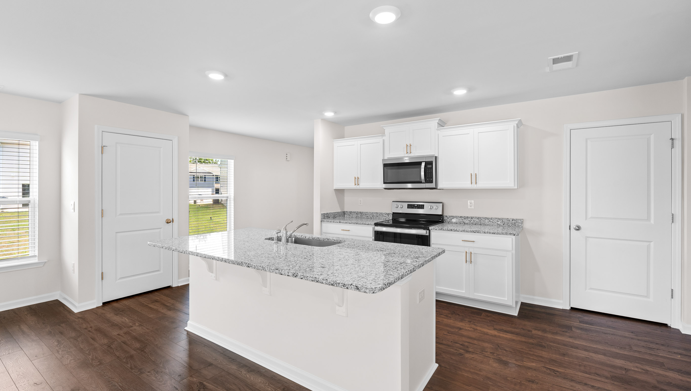 Kitchen and island with granite counter tops.