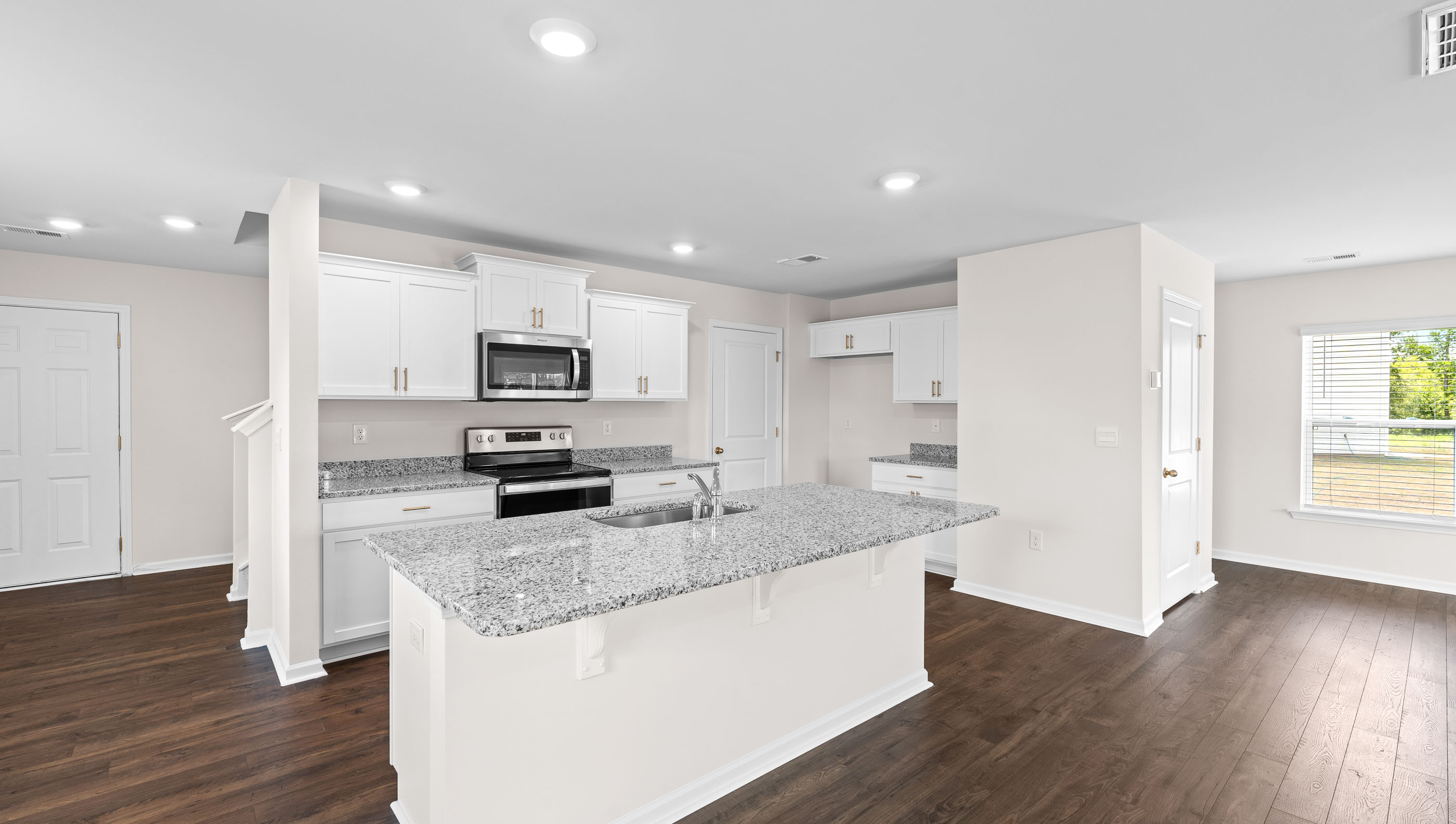 Kitchen and island with granite counter tops.