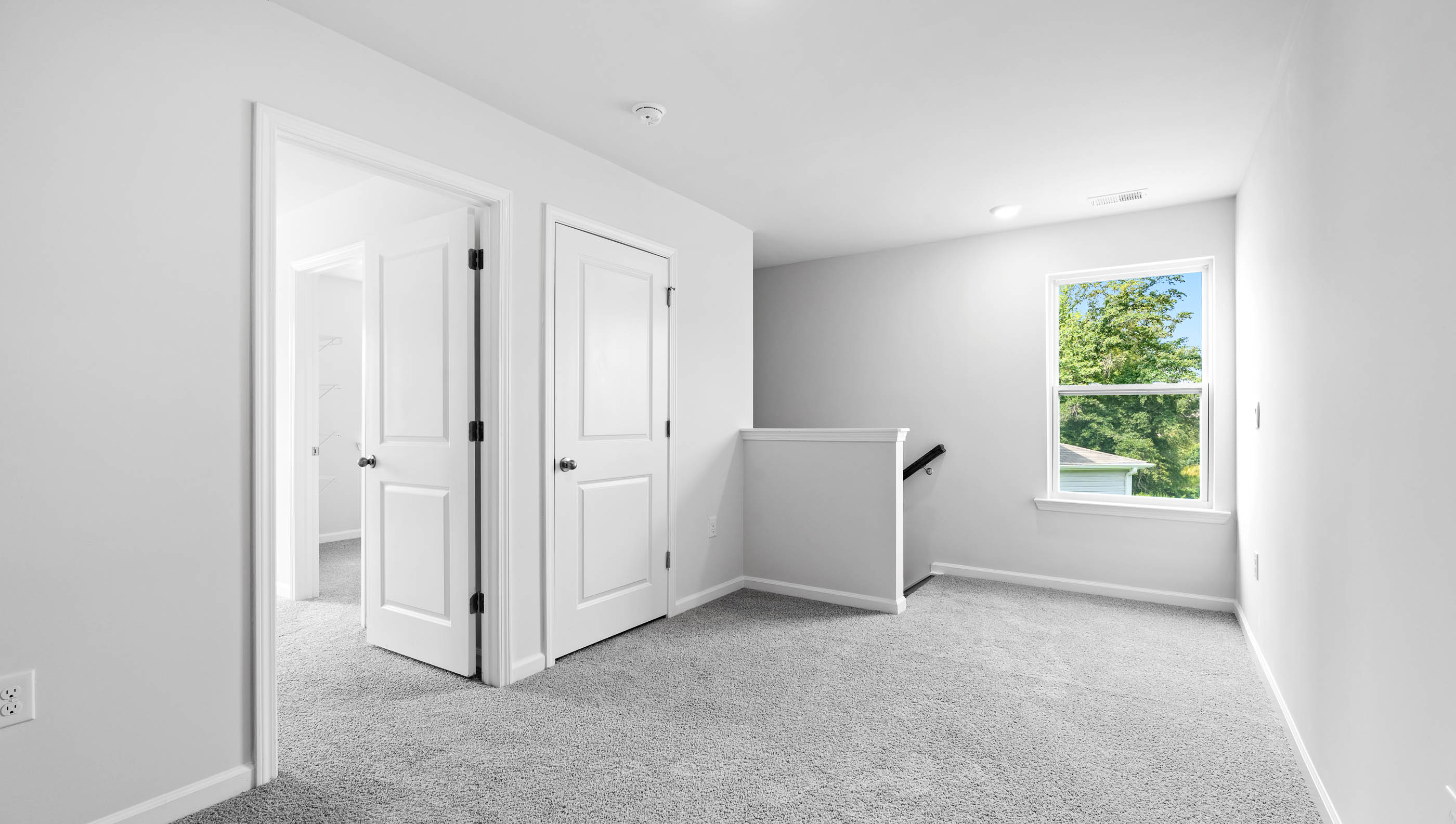 Loft area with carpet and window.