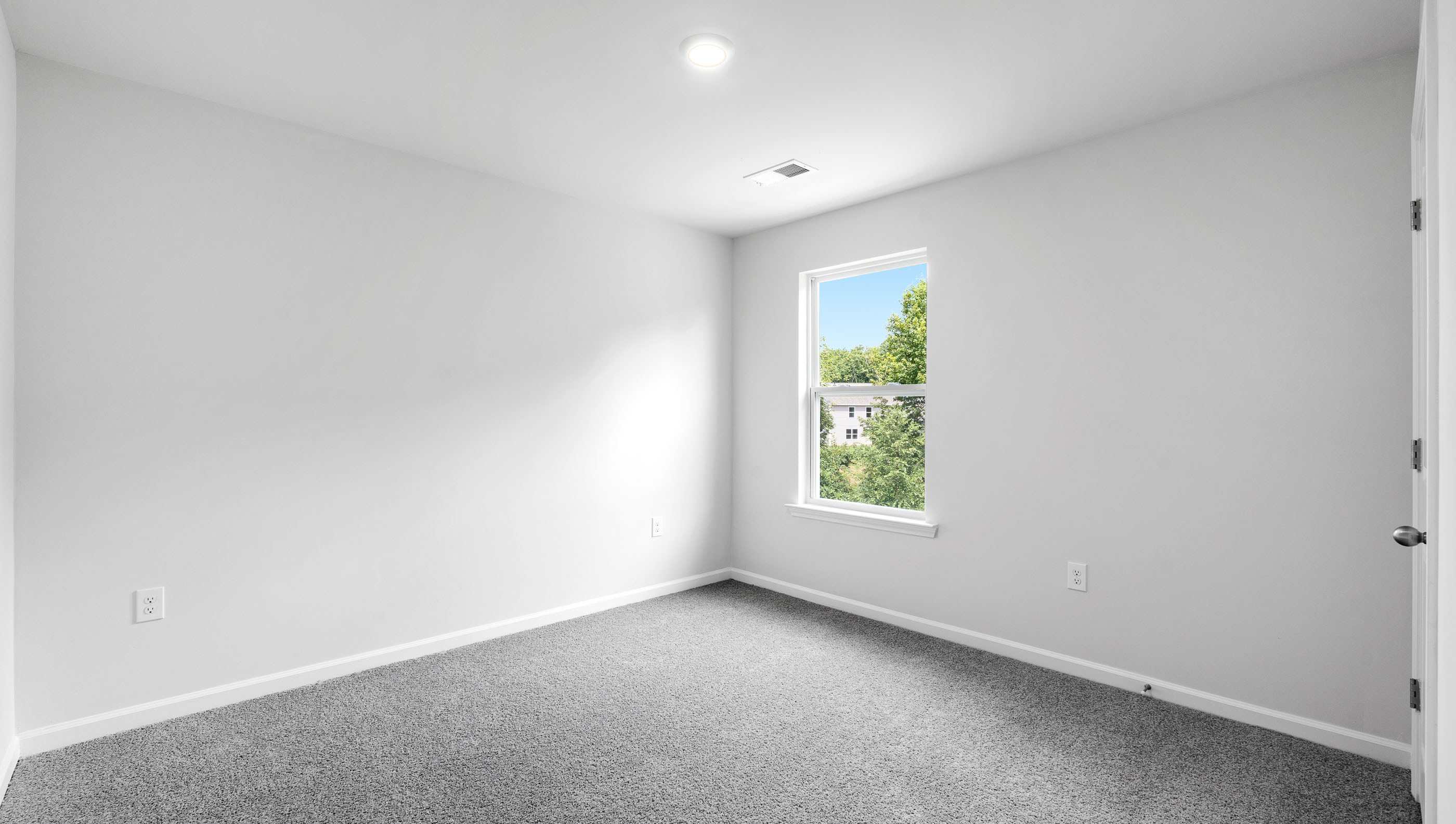Bedroom with carpet and window.