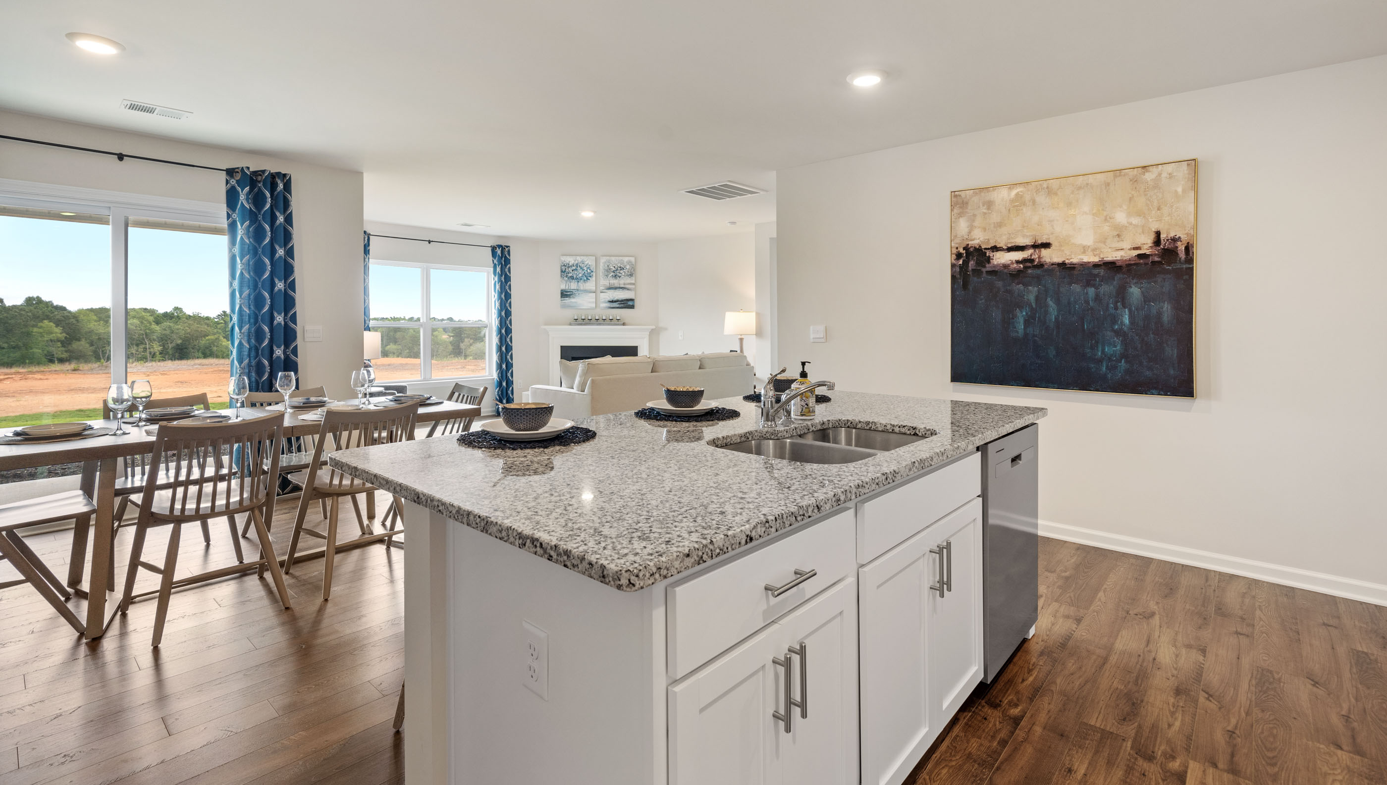 Kitchen and island with granite counter tops and windows.