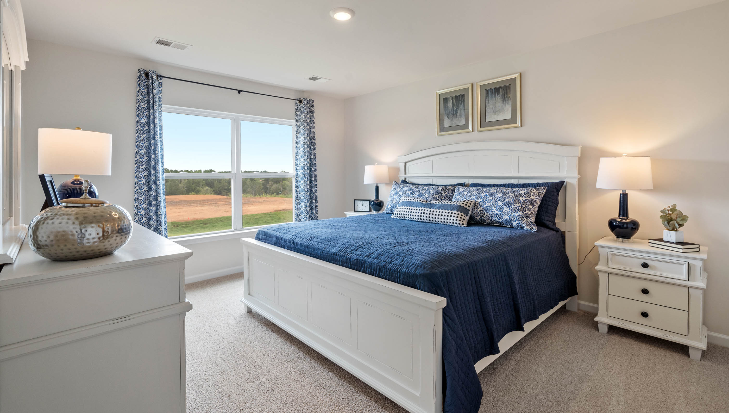 Bedroom with carpet and windows.