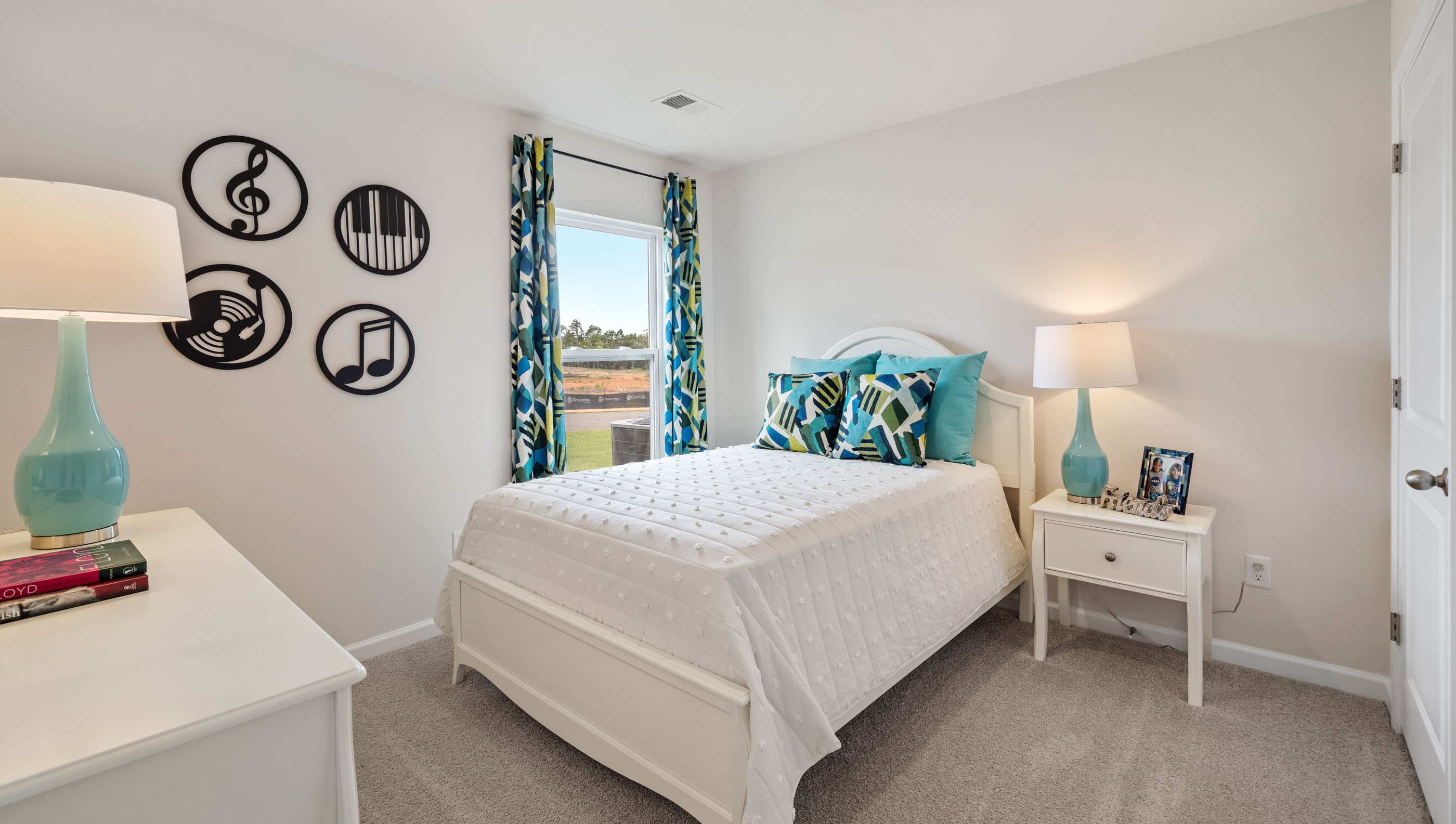 Bedroom with carpet and window.